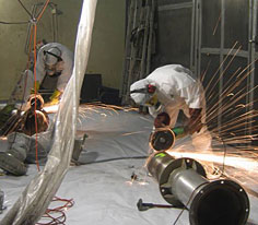 Operators carrying out cutting operations during decommissioning of the ATUE in Cadarache (Bouches-du-Rhne dpartement)