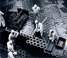 Operators constructing a graphite assembly in a reactor